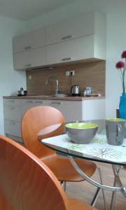 a kitchen with a table with two bowls on it at Apartment Olomouc in Olomouc