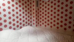 a bedroom with a polka dot wall and a bed at La vie en Rosans - The house in Saint-André-de-Rosans