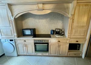 a kitchen with a sink and a microwave at Maison du Roy/ Upper Cambers in Saint-Antonin +82 photos