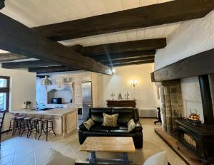a living room with a couch and a fireplace at Maison du Roy/ Upper Cambers in Saint-Antonin
