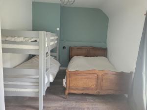 a bedroom with two bunk beds and a ladder at Gîte La nouette in Plémet +5 photos