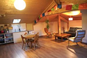 a living room with a table and chairs and a couch at Eco-gîte Belle-étoile in Verrens-Arvey +15 photos