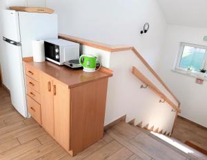 a kitchen with a counter with a microwave and a refrigerator at Noclegi Zalewo in Zalewo