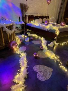 a room with a bed with lights on the floor at MIŁOŚĆ ma swój adres - ZMYSŁOWE apartamenty z JACUZZI dla Dwojga in Ełk