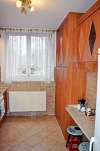 a kitchen with a window with a radiator in it at Belvárosi Classic Apartman 85 square meters in Szombathely