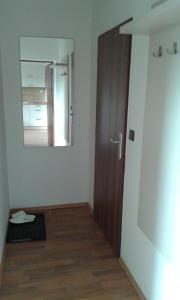 a room with a door and a mirror on the wall at Apartment Olomouc in Olomouc