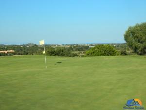 a golf course with a flag on the green at Casa Agostina in Pula