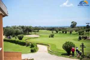 a group of people standing on a golf course at Casa Agostina in Pula