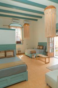 a large bedroom with two beds and a couch at Hotel Casa Puerta de Mar in Campeche