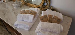 a pile of towels on a counter in front of a mirror at Casa Rosa in Cassina Valsassina