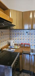 a kitchen with wooden cabinets and a counter top at Casa Rosa in Cassina Valsassina +7 photos