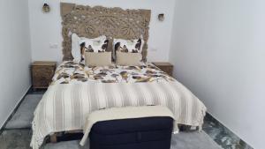 a bedroom with a large bed and a blue chair at Résidence Dica T2 in Port-Saint-Louis-du-Rhône +7 photos