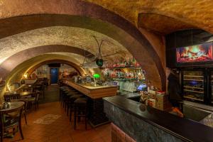 a bar with a row of tables and chairs in a building at Studio Nicolas II Prague in Prague
