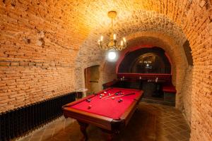 a room with a pool table in a brick wall at Studio Nicolas II Prague in Prague