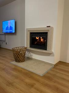 a living room with a fireplace with a tv at The New Inn in Bansko