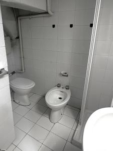 a bathroom with a toilet and a bidet at Come a casa in Trani +4 photos
