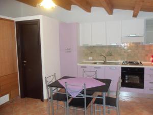 a kitchen with a table and chairs in a room at Casa Andrea in Cefalù