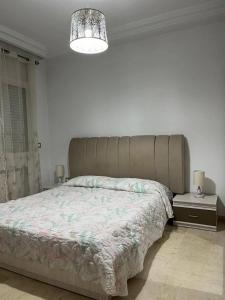 a bedroom with a large bed with a large headboard at carfort House in Al Jafr +12 photos