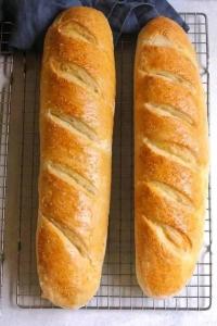 two loafs of bread sitting on a cooling rack at carfort House in Al Jafr