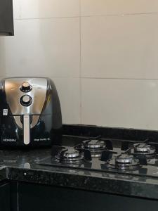 a toaster sitting on top of a stove in a kitchen at Belô Home & Office in Belo Horizonte +40 photos