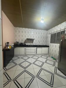 a kitchen with a white and black tile floor at Casa Maravilha in Ananindeua