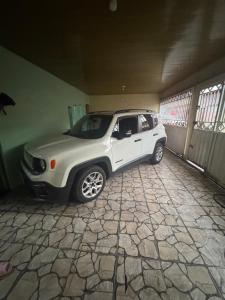 a white jeep parked in a garage at Casa Maravilha in Ananindeua