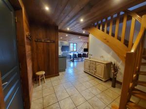 a staircase leading to a kitchen and a living room at Chalet de la Rougeterre in Le Ménil