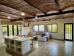 a living room with a couch and a table at Tropical paradise awaits! in Platanitos