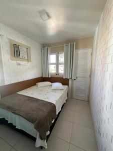 ein Schlafzimmer mit einem großen Bett und einem Fenster in der Unterkunft Serrambi Paradise in Porto De Galinhas + 23 Fotos