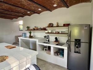 a kitchen with a stainless steel refrigerator in a room at Tropical paradise awaits! in Platanitos