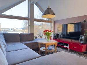 a living room with a couch and a table at Cozy and Central Loft in Tromsø in Tromsø