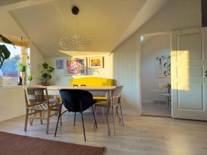 a dining room with a yellow table and chairs at Cozy and Central Loft in Tromsø in Tromsø