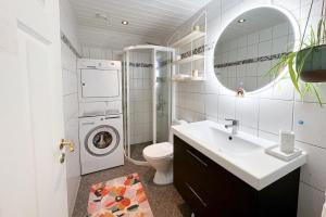 a bathroom with a sink and a washing machine at Cozy and Central Loft in Tromsø in Tromsø +27 photos