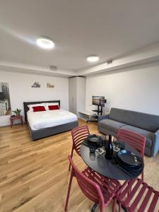 a bedroom with a bed and a table and chairs at LikeHome PortaReno Monolocale Exclusive - 4 pxs in Ferrara