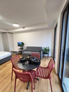 a living room with a table and chairs and a couch at LikeHome PortaReno Monolocale Exclusive - 4 pxs in Ferrara +9 photos