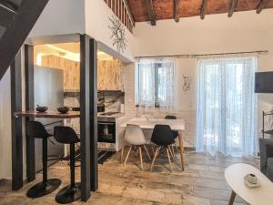 a kitchen and dining room with a table and chairs at The stone house in skiathos in Skiathos