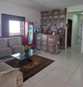 a living room with a couch and a coffee table at Pousada Eldorado in Lauro de Freitas +7 photos