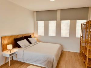 Postel nebo postele na pokoji v ubytování Alagoas Studio - City Center