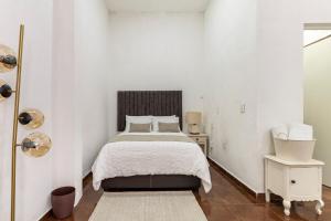 Giường trong phòng chung tại Suite Copal