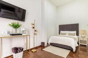 Giường trong phòng chung tại Suite Copal