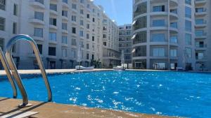 une grande piscine devant un immeuble dans l'établissement Scandic Resort Hurghada, à Hurghada
