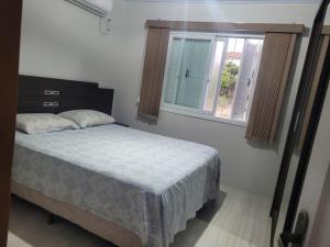 En eller flere senge i et værelse på Casa próxima ao Centro