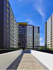a walkway in a city with tall buildings at Avida Atria Tower 4 in Iloilo City