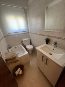 a bathroom with a white toilet and a sink at Apartamento Salou 2 playas, 2 km PortAventuraWorld in Salou +20 photos