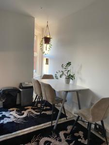 a dining room with a white table and chairs at Marble House in Edgware