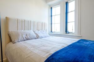 a bedroom with a large bed with two windows at Bury 2 Bedroom 1 Bathroom in Town Center Sleeps 4 in Bury