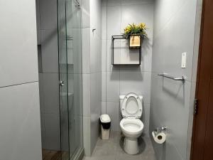 a bathroom with a toilet and a glass shower at La Paz Department VIP in La Paz +7 photos