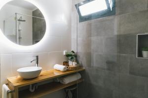 a bathroom with a sink and a mirror at Central Charm Azores in Ribeira Grande