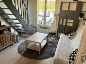 a living room with a couch and a table at Harmonie in Aulnay-sous-Bois