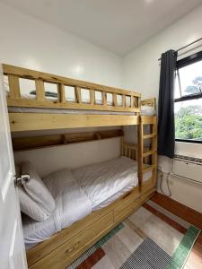two bunk beds in a room with a window at Casa Bella -1 Free Scooter in Baclayon